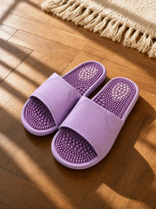 Amethyst — Zenith women's reflexology slides in lilac with a purple footbed, on a warm oak floor beside a linen rug