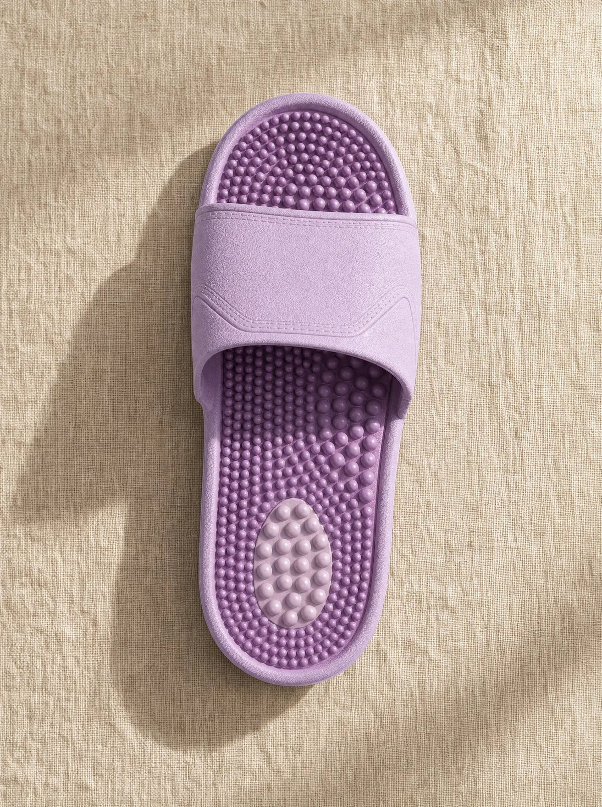 Close-up of the Zenith reflexology footbed in Amethyst — acupressure nodules across the sole