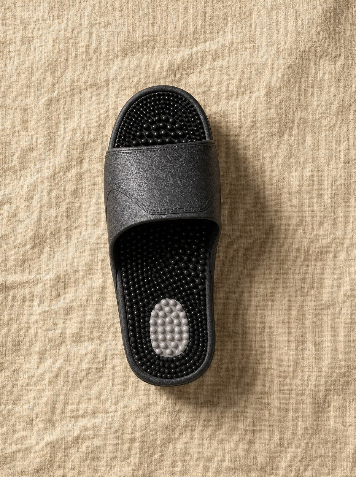 Close-up of the Zenith reflexology footbed in Obsidian — acupressure nodules across the sole