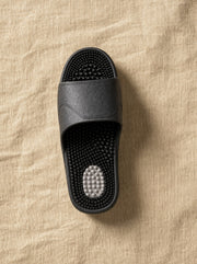 Close-up of the Zenith reflexology footbed in Obsidian — acupressure nodules across the sole
