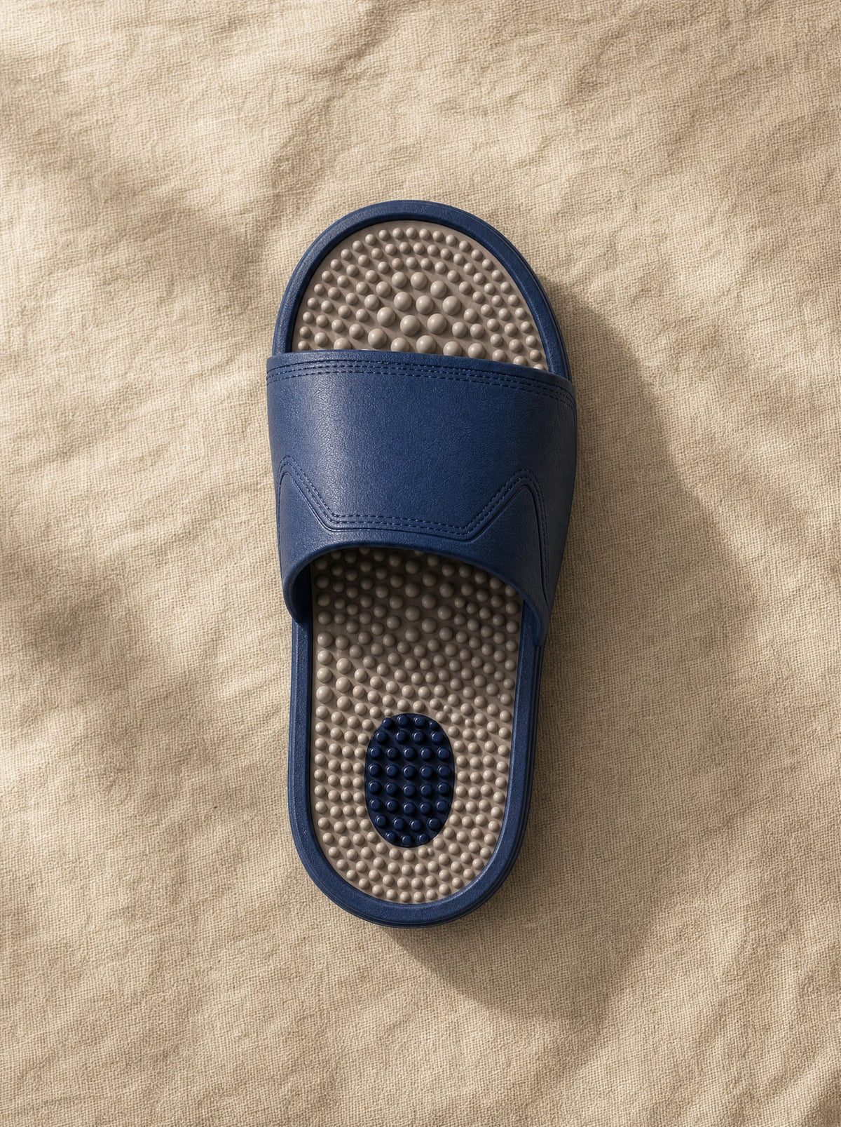 Close-up of the Zenith reflexology footbed in Steelwater — acupressure nodules across the sole